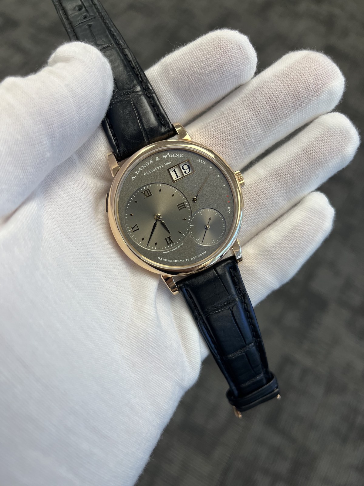 A. Lange & Söhne luxury watch held in a white glove